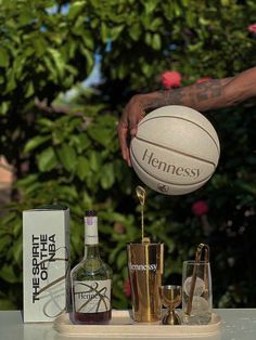 a man is pouring liquor into a basketball