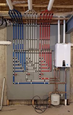 pipes and water heater in an unfinished room