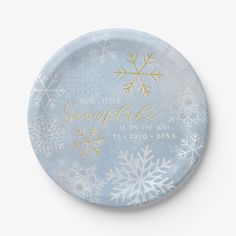 a paper plate with snowflakes on it that says our little snowflake is on the way