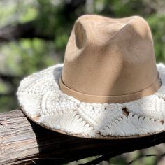 a hat is sitting on top of a piece of wood