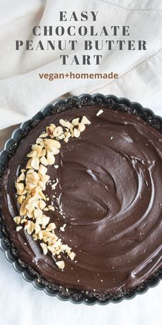 an easy chocolate peanut butter tart is shown in a pie pan with nuts on top