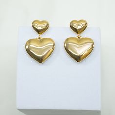 our Crazy On You Drop Earrings are an absolute must-have for a night out and the perfect piece to dress up a simple daytime look. these delightful heart earrings will compliment your look with some extra sparkle and charm. 18k gold pvd over 316 stainless steel water resistant post back 27mm total length top heart measures 9mm bottom heart measures 16mm Brazilian Gold, Synthetic Diamond, Gold Bond, Steel Water, Cultured Pearls, Heart Earrings, Gold Vermeil, Precious Stones, Sale Items