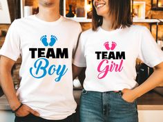 two people standing next to each other wearing matching t - shirts that say team boy and girl