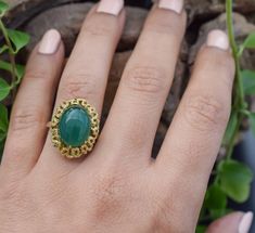 Vintage agate ring, a captivating design that lets you make a statement wherever you go. The green stone gives the ring a mesmerizing look. The design around the stones has yellower color to make the stone pop out even more. The design at the bottom of the ring is stunning, it really gives the ring the detail to set itself apart from other rings. A true piece of art. ■Design: Handcrafted agate ring ■Material: Solid 14k yellow gold ■Stamped: 585 Gold ■State: The ring is in excellent condition. ■R Vintage Emerald Ring As A Gift, Vintage Green Opal Ring, Green Oval Chalcedony Rings, Oval Green Chalcedony Rings, Vintage Green Emerald Open Ring, Vintage Style Open Emerald Ring For Gift, Vintage Green Oval Opal Ring, Vintage Emerald Green Open Ring, Vintage Agate Rings For Anniversary