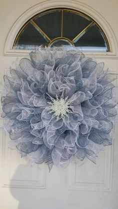 a blue wreath hanging on the front door