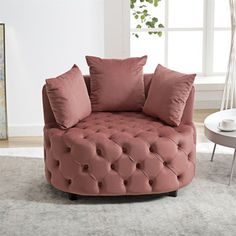 a living room with a round couch and pillows