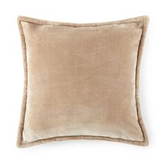 a beige pillow on a white background