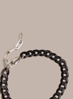 We love this super unique chain link. Starting up with the ultra wide, ultra flat cuban link and then elevated with the Titanium Coating. Add to that the contrast of the 925 Sterling Silver clasp and extender and you end up with a futuristic yet modern unique chain bracelet. Add this to the "for the man who has it all" collection. Chain Links: 8mm Material: Titanium Coated over Sterling Silver. Note the titanium will reveal specks of the silver underneath. It is the intended look to reveal an ef Modern Chunky Chain Cuban Link Bracelets, Modern Bracelets With Chunky Cuban Link Chain, Modern Cuban Link Chain Bracelet With Solid Construction, Modern Chunky Cuban Link Chain Bracelet, Modern Cuban Link Bracelet With Chunky Chain, Modern Chunky Cuban Link Bracelet, Modern Chunky Chain Cuban Link Bracelet, Modern Silver Cuban Link Chain Bracelet, Modern Cuban Link Chain Bracelet