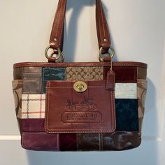 Coach Holiday Patchwork Gallery Tote (Vintage And In Like-New Condition) Multimedia Tote Bag Including Napa Leather, Dusted Suede, Suede, Signature Jacquard, Velvet, Crinkle Patent Leather, Metallic Leather. No Wear On Leather Handles Or Bottom. Tote Bag Is In Excellent Condition, Used Lightly And Infrequently. Roomy And Functional Interior With Royal Blue Sateen Lining. Has One Zipper Pocket On Inside Plus Two Multifunction Pockets. Lightly And Infrequently Used So Still In Excellent Condition. Please See Photos For Minor Mark On Suede On One Side Of The Bottom. Zip Closure. Outside Pocket Strap With 8 1/4" Drop. Bag Is 12 1/2" (L) X 9" (H) X 4 1/2" (W) Asking $100 Multicolor Coach Shoulder Bag With Double Handle, Coach Multicolor Bag With Handles, Vintage Coach Patchwork Bag, Coach Burgundy Shoulder Bag With Gold-tone Hardware, Multicolor Coach Bags With Gold-tone Hardware, Metallic Leather, Vintage Colors, Coach Bags, Leather Handle