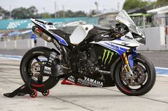 a yamaha racing motorcycle parked on the track