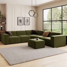 a living room with a large green couch and two brown pillows on the rugs