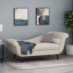 a living room with pink couches and pictures on the wall above them, along with a rug