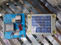 an electronic device sitting on top of a piece of blue paper with wires attached to it