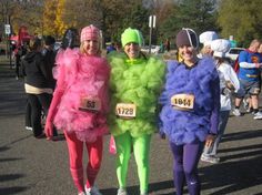 three people dressed in costumes for a race