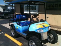 a blue golf cart parked in front of a building