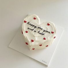 a heart shaped cake with writing on it