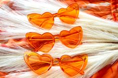 three heart shaped glasses sitting on top of white fur