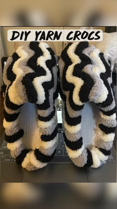 two black and white zebra print slippers on top of each other with the words diy yarn crocs written above them