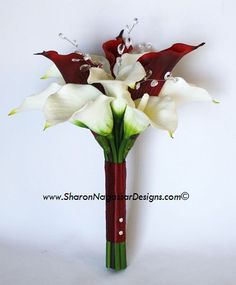 white and red flowers are in a vase