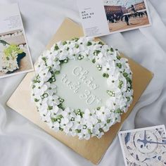 there is a cake with flowers on it and pictures around the cake that says congratulations