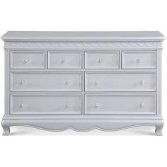 a white dresser with many drawers and knobs