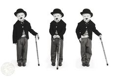 three young boys wearing hats and holding canes in their hands, all with different facial expressions