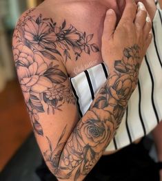 a woman with tattoos on her arm and chest holding her hands to her face while looking at the camera