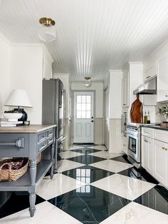 a black and white checkered floor in a kitchen