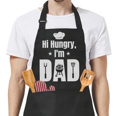 a man wearing an apron that says hi hungry, i'm dad with cooking utensils