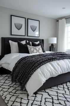 a large bed sitting in a bedroom next to two pictures on the wall above it