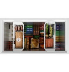 an open refrigerator filled with lots of different types of vegetables and food in bins