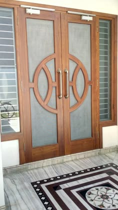 an entry door with two glass panels on the front and side doors that have circular designs