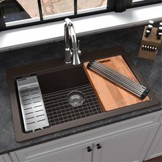 a kitchen sink with cutting board and knifes on the counter top next to it