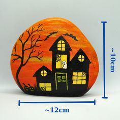 a rock with a house painted on it