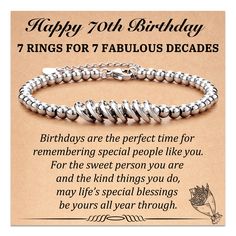 a happy 70th birthday card with a silver beaded bracelet and an inscription on it