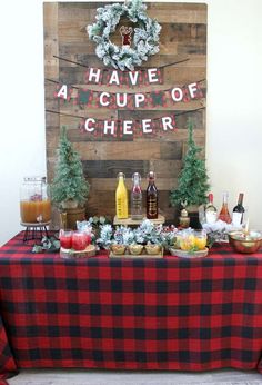 a table topped with lots of food next to a sign that says have a cup of cheer