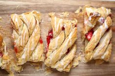 several pastries are lined up on a cutting board with cranberry toppings