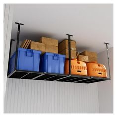 boxes and crates are stacked on the shelf above the garage storage bins in this room