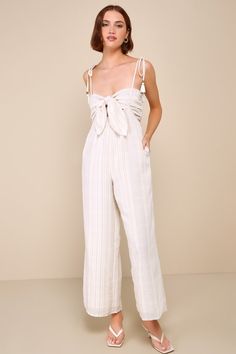 Stroll through the resort looking (and feeling) amazing in the Lulus Confident Pick Ivory Striped Tie-Front Two-Piece Jumpsuit! Lightweight woven linen-like fabric boasts a summery striped design as it shapes a tie-front bandeau-style crop top with smocking at back. Tying spaghetti straps (with tasseled ends) support relaxed high-rise pants with side seam pockets and wide legs that layers atop for a cool two-piece look. Fit: This garment fits true to size. Length: Ankle length. Size medium Insea Two Piece Jumpsuit, Adhesive Bra, High Rise Pants, Striped Tie, Wide Legs, Women's Summer Fashion, Stripes Design, Boho Outfits, Ankle Length