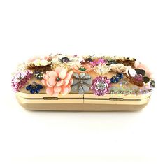 Embrace timeless elegance with a floral flourish. The Floral Pearl Elegance Clutch Bag is a stunning accessory adorned with intricate beadwork, sequins, and pearls, creating a delicate 3D floral pattern that captivates with every detail. This beautifully embellished clutch blends hues of pink, gold, silver, white, and pastel blush with hints of green, purple, and blue, evoking a harmonious bouquet of colours that adds dimension to any outfit. An exquisite choice for weddings or any special occas Flower Luxury, Bridal Purse, Sequin Clutch, Party Handbags, Chain Handbag, Best Purses, Wedding Purse, Satin Bags, Beaded Bag