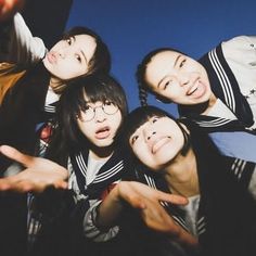 four young people are posing for the camera