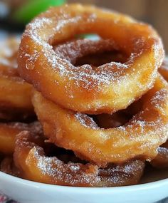 some sugared doughnuts in a white bowl