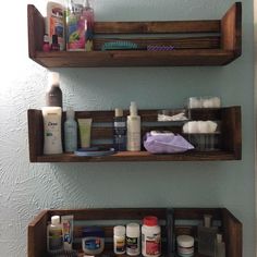 two wooden shelves filled with cosmetics and personal care items