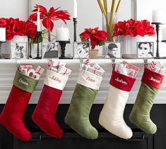 christmas stockings hanging from a mantel decorated with poinsettis