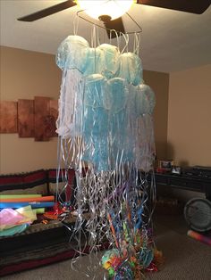 a room with plastic bags hanging from the ceiling and some balloons in the air above it