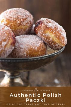 powdered sugar covered donuts in a glass bowl