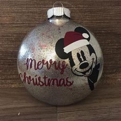 a mickey mouse ornament with merry christmas written on it