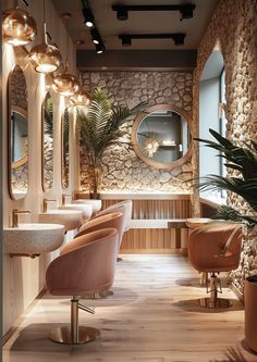 the interior of a hair salon with chairs and mirrors on the wall, potted plants