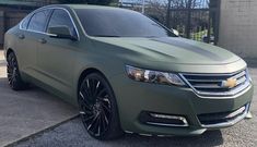 a green car parked in front of a building