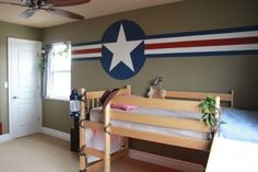 a bedroom with two bunk beds and a flag wall decal on the wall behind it